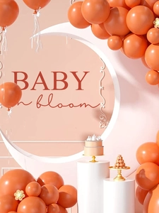 Baby in bloom party decor with warm orange balloons and dessert display for baby shower