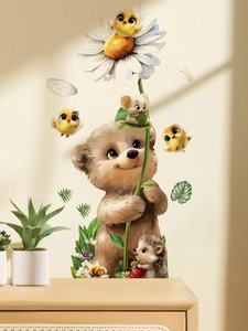 Detail view of cartoon bear, birds and hedgehog wall decals in a cozy nursery setting