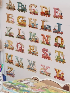 Detail of 26 alphabet train wall stickers in a cozy kids study room with desk decor