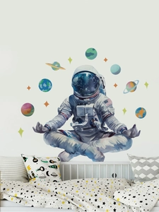 Close-up of watercolor astronaut and planets wall decal in a cozy boy bedroom setting