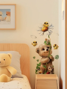Detail of cartoon bear and honeybee wall stickers applied in a warm bedroom setting