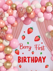 Close-up of strawberry theme Berry First Birthday backdrop with pink and gold balloon arch