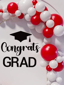 Detail view of red and white balloon arch on a golden circular frame for graduation