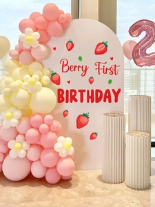 Strawberry first birthday arch backdrop with pink balloons and Berry First sign