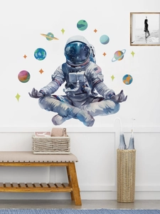 Watercolor astronaut wall sticker with colorful planets in a modern bedroom interior setting