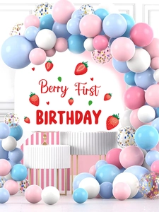 Detail of Berry First Birthday party arch with pink balloons and strawberry backdrop