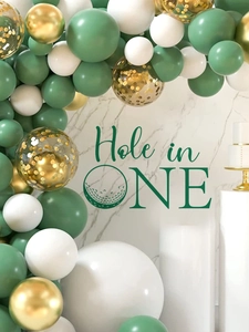 Detailed view of Hole in One golf themed balloon arch with gold and sage green balloons