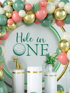 Golf theme party setup with Hole in One sign, colorful balloons and palm leaves