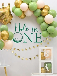 Detailed close-up of golf-themed birthday party arch with crown balloons and wall decals