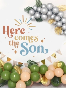 Detail of baby shower kit with sage green balloons and Here comes the Son sign