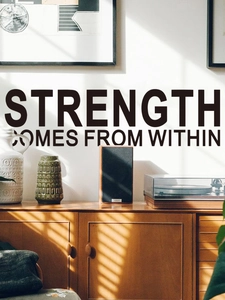 Detail of inspirational phrase wall sticker above a vintage cabinet with nordic decor