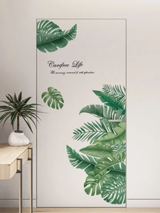 Close-up of tropical monstera palm leaf wall decals with Carefree Life text art