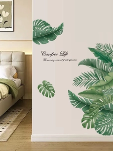 Detail of tropical green plant wall stickers and Carefree Life text in a bedroom