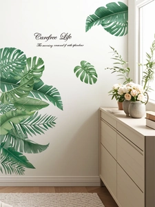Detail of tropical monstera leaf wall decals with Carefree Life text in a modern room