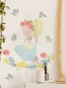 Detail of floral girl and blue birds wall stickers on a clean white bedroom wall