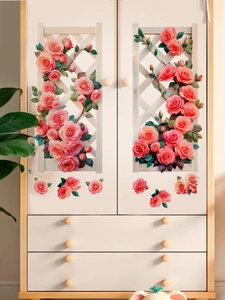 Close-up of 3D rose wall stickers with pink floral patterns on a white cabinet surface