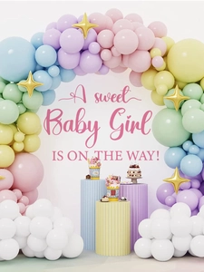 Close-up of pastel balloon arch kit with gold star accents for baby shower party backdrop