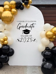 Close-up of black, gold and white balloon arch with 2025 graduation backdrop sticker