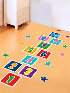 Detail of colorful number hopscotch floor stickers for kids room on wood floor