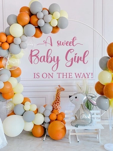 Detail of baby shower balloon arch with giraffe and bunny foil balloons on white stand