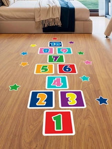 Colorful number hopscotch floor stickers for kids room with decorative stars on wood floor