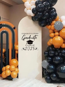 Detail of Class of 2025 graduation backdrop with congratulations stickers and balloons