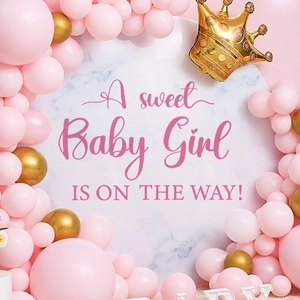 Pink and gold balloon arch kit for baby shower party with a sweet baby girl theme backdrop
