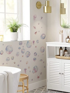 Detail of colorful bubble and shell ocean wall stickers in a bright bathroom setting
