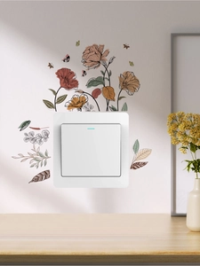 Floral wall stickers with butterfly accents decorating a white light switch in a cozy room