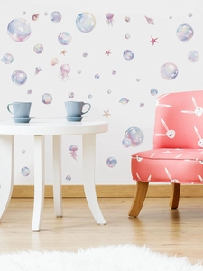 Detail of watercolor ocean bubble wall decals with shells and starfish in a nursery setting