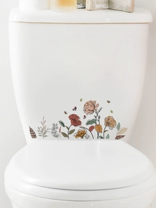 Detailed view of floral and butterfly PVC wall decals applied to a white toilet tank