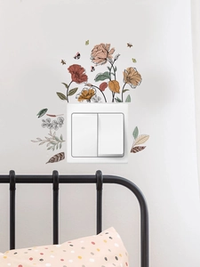 Detail of colorful floral and butterfly PVC wall stickers applied around a light switch
