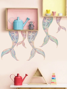 Detail of dream mermaid tail wall stickers with gold scales on a soft pink wall