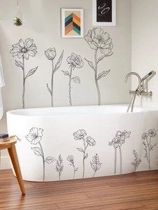 Detailed view of black floral line art stickers applied on a bathtub and bathroom wall