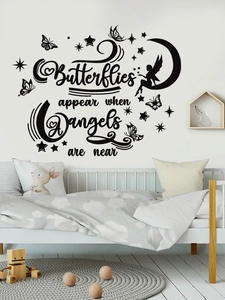 Detail of wall sticker showing butterflies and angels are near quote in a cozy bedroom