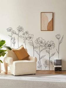 Black line floral wall stickers displayed in a modern living room near a beige sofa