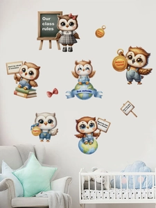 Close-up of cartoon owl wall stickers with educational quotes on a warm nursery wall