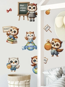 Detail showing educational owl wall stickers with motivational quotes on a white wall