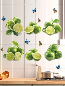 Close-up of fresh lime and colorful butterfly wall stickers on white kitchen tiles