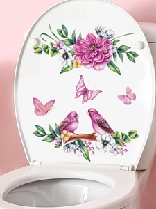 Detail of floral wall sticker with pink birds and butterflies on a white toilet lid