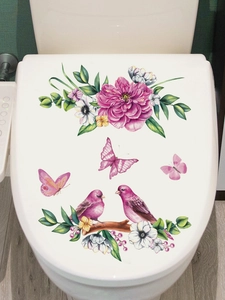 Detail of pink floral wall stickers with birds and butterflies on a white toilet lid cover