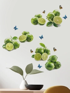 Detail showing fresh green lemon and colorful butterfly wall decals on a clean white wall