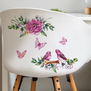 Pink floral wall decals with birds and butterflies on a white chair in a modern setting