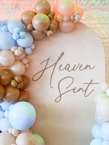 Detail of Heaven Sent party arch with blue and coffee morandi balloons decorations