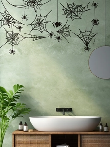 Detail of black spider web wall stickers applied on bathroom walls for Halloween decor