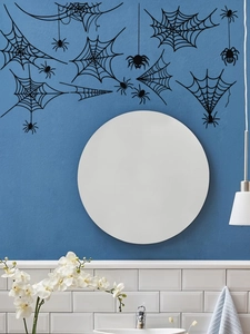 Detail of self-adhesive black spider web wall stickers on a bathroom wall for Halloween