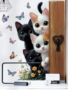 Detail showing cute large-eyed cats and colorful butterflies wall decals on a white wall