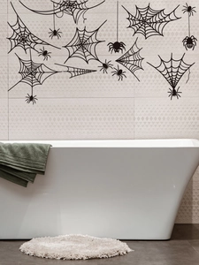 Detail of black spider and cobweb wall stickers applied on tiled bathroom walls