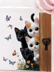 Detail of cute cat and butterfly wall stickers on a light wood door for room decor