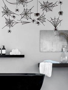 Detail of black spider web wall stickers on grey bathroom wall for Halloween decor
